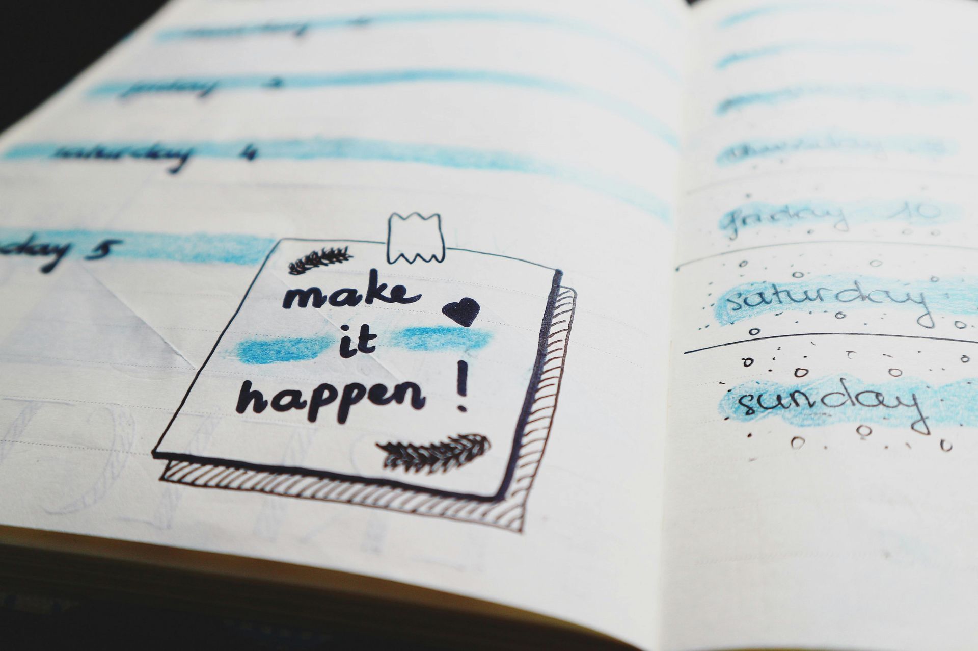 A notebook is open to a page that says make it happen