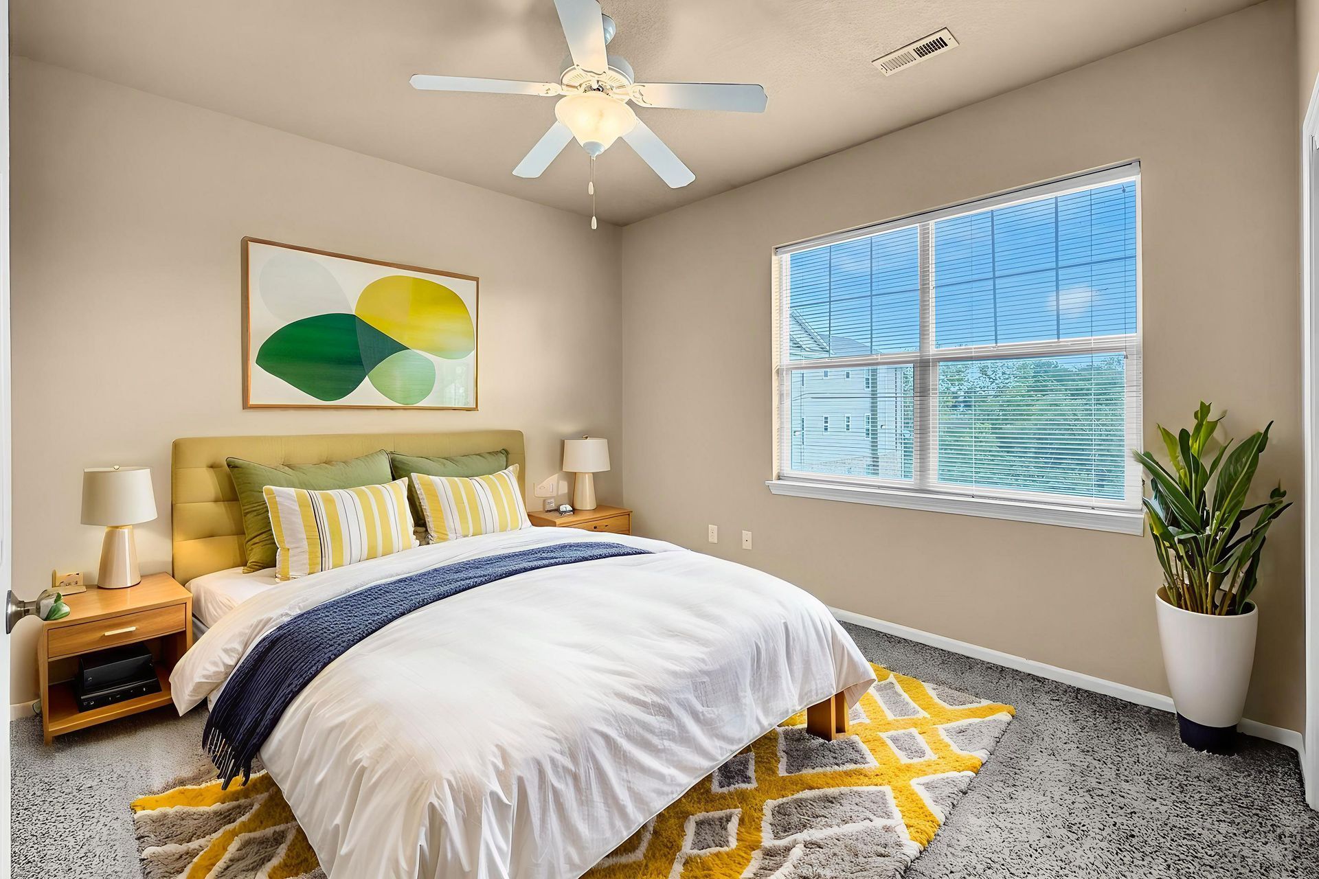 Kitchen with brown cabinets, white appliances, and a window above a double sink.