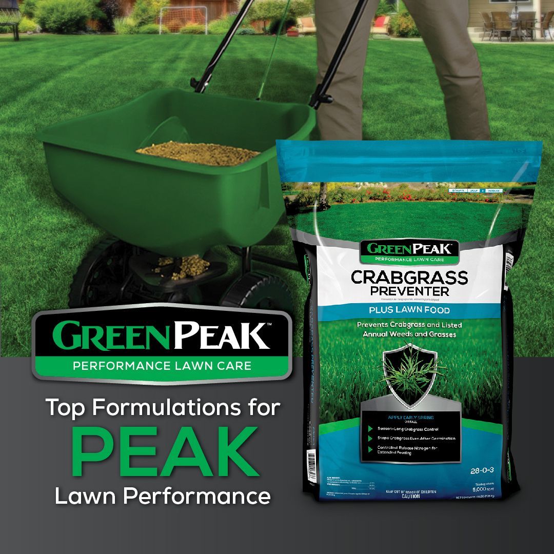 A person is spreading green peak crabgrass preventer plus lawn food on a lush green lawn