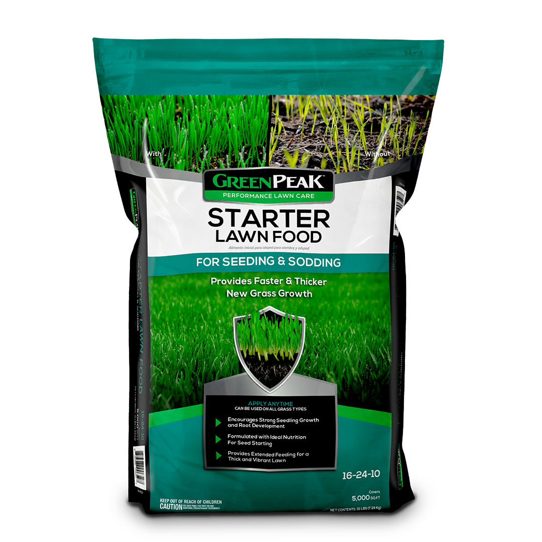 A teal, white, and black bag of green peak starter lawn food for seeding & sodding on a white background.