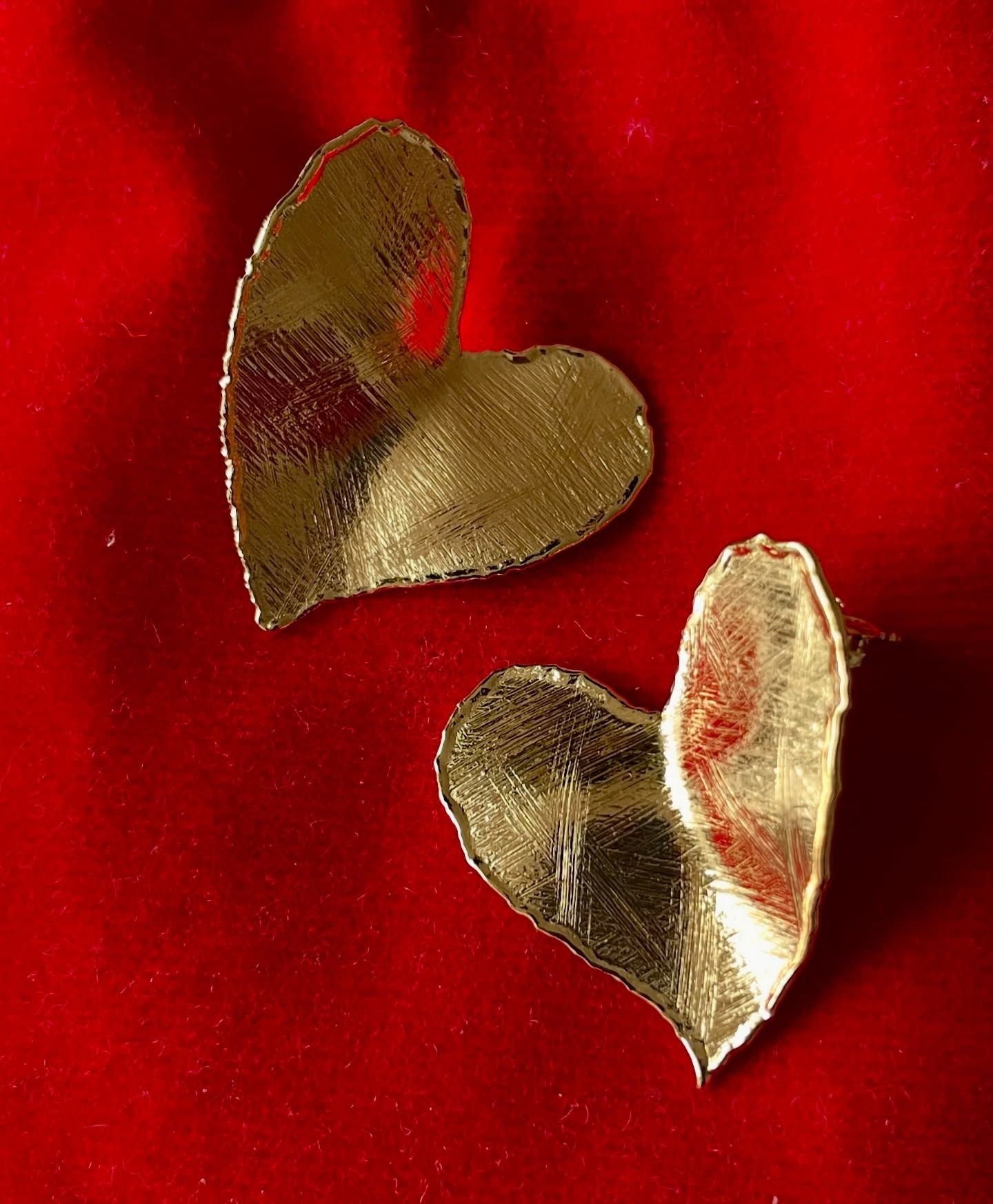 Due cuori d'oro sono seduti su un panno rosso