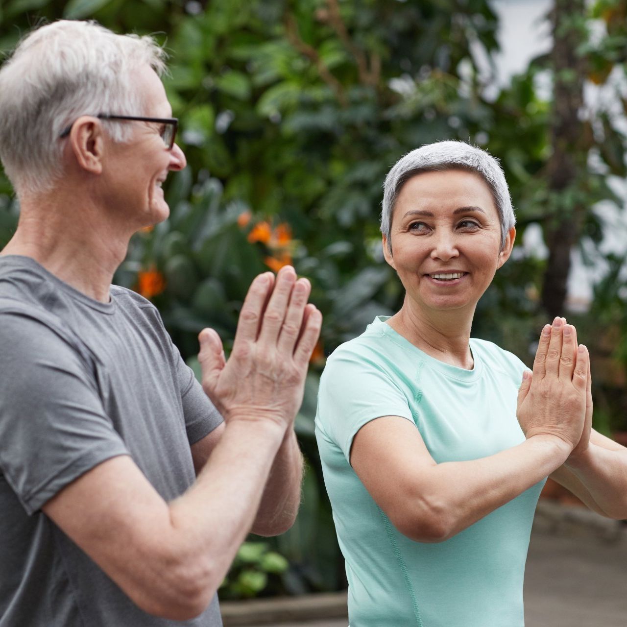 A man and a woman are clapping their hands together.