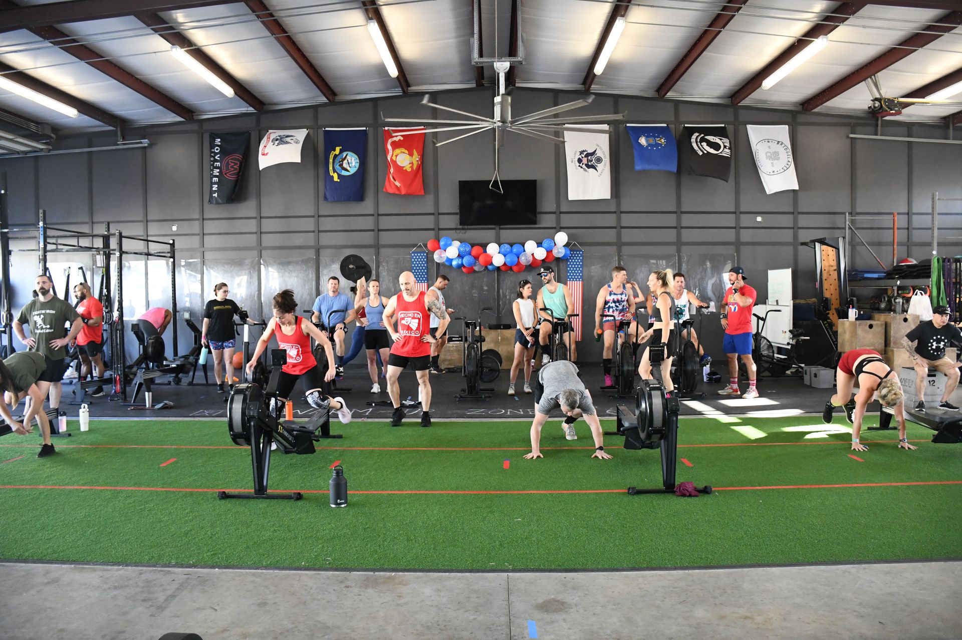 A group of people are doing exercises in a gym.