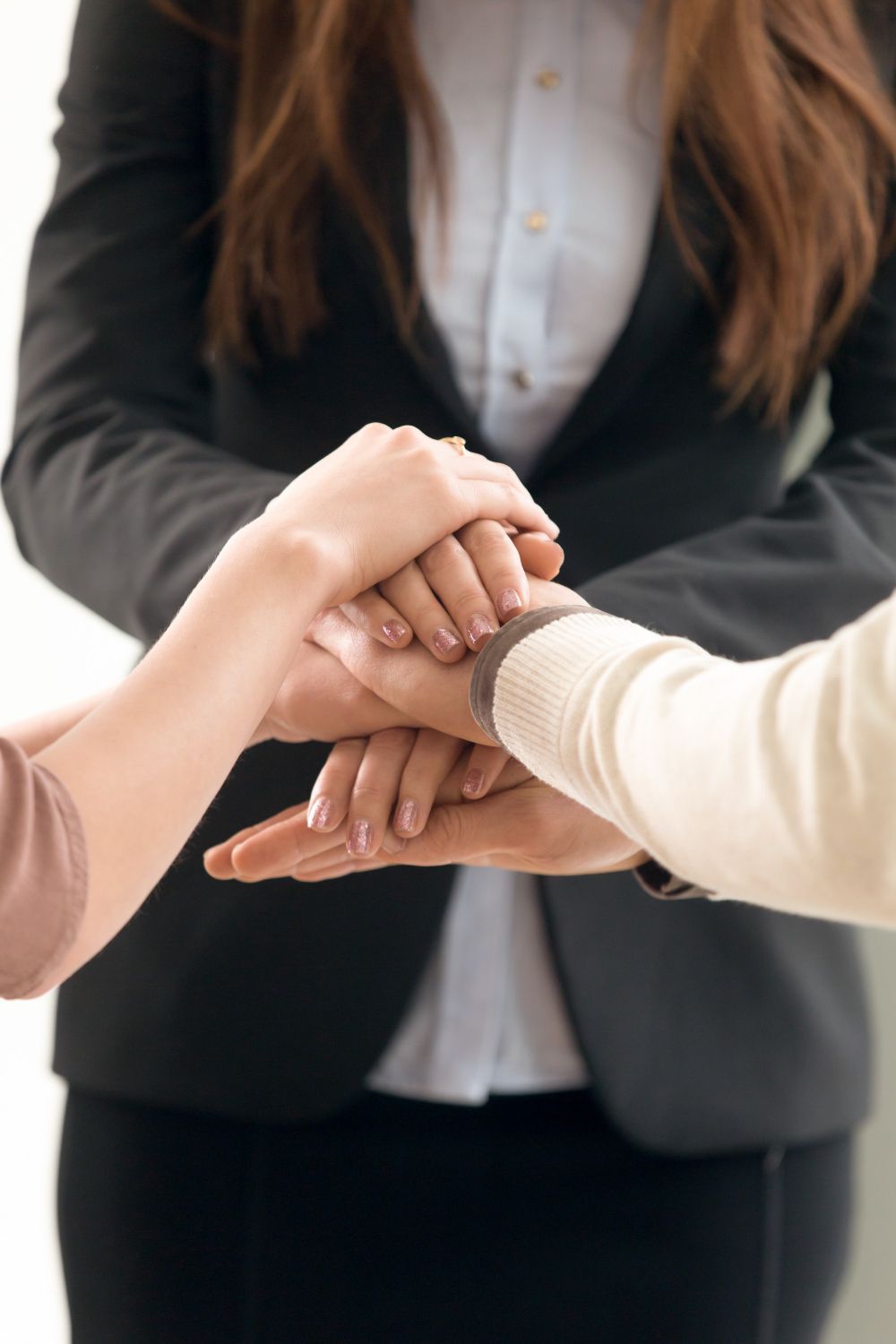 A woman is sitting at a desk with a statue of justice.