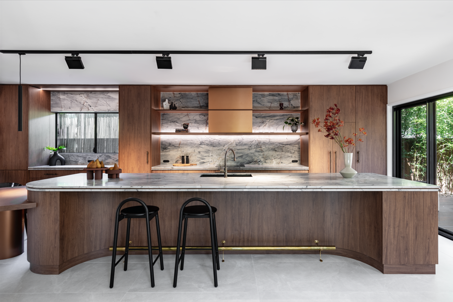 Modern kitchen with marble countertops, wooden cabinetry, built-in open shelves, two black bar stools — Onyx Detailed Joinery In Unanderra, NSW