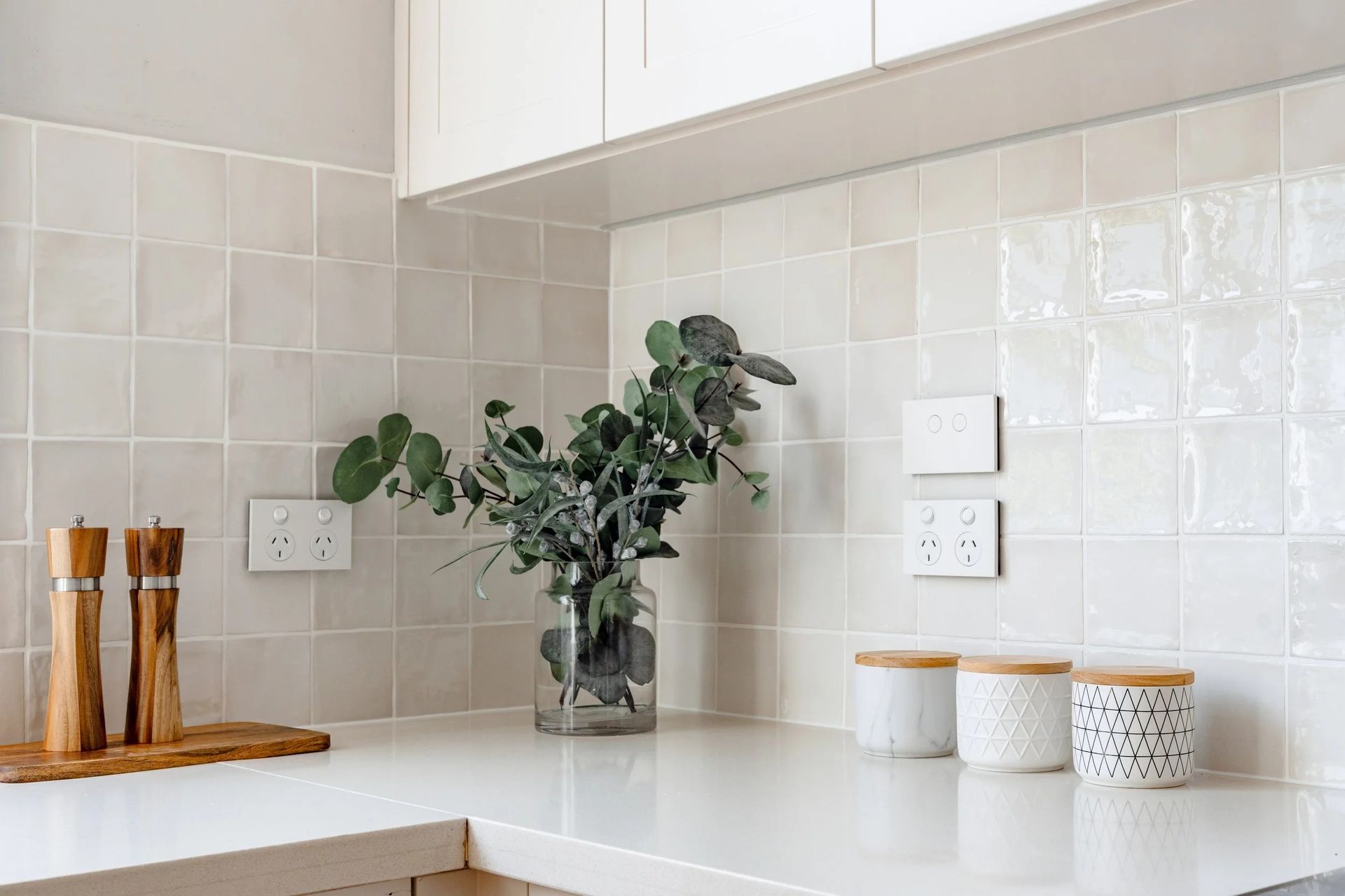 Kitchen Countertop With a Vase of Greenery — Onyx Detailed Joinery in Unanderra, NSW
