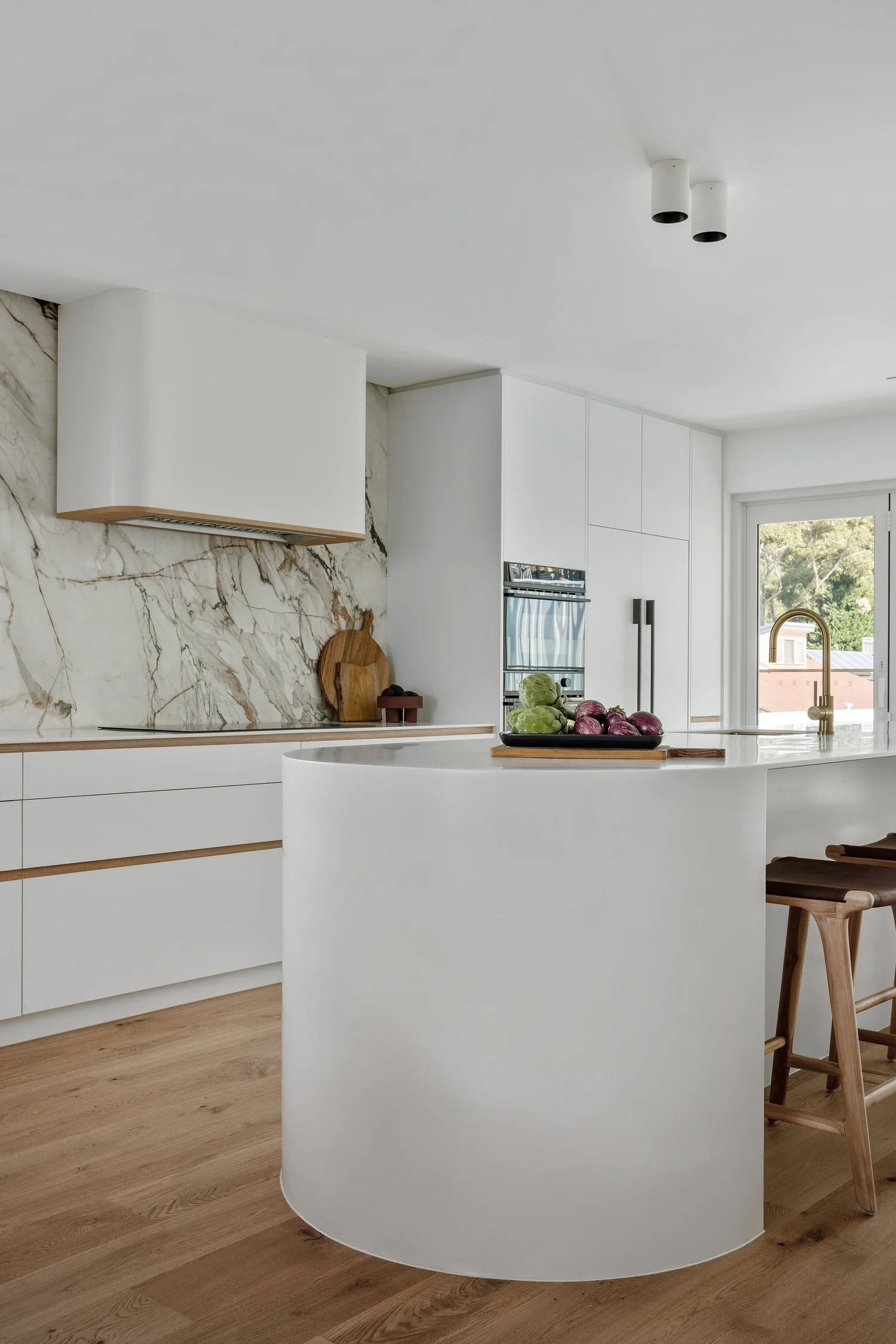 White Kitchen With Curved Island — Onyx Detailed Joinery in Unanderra, NSW