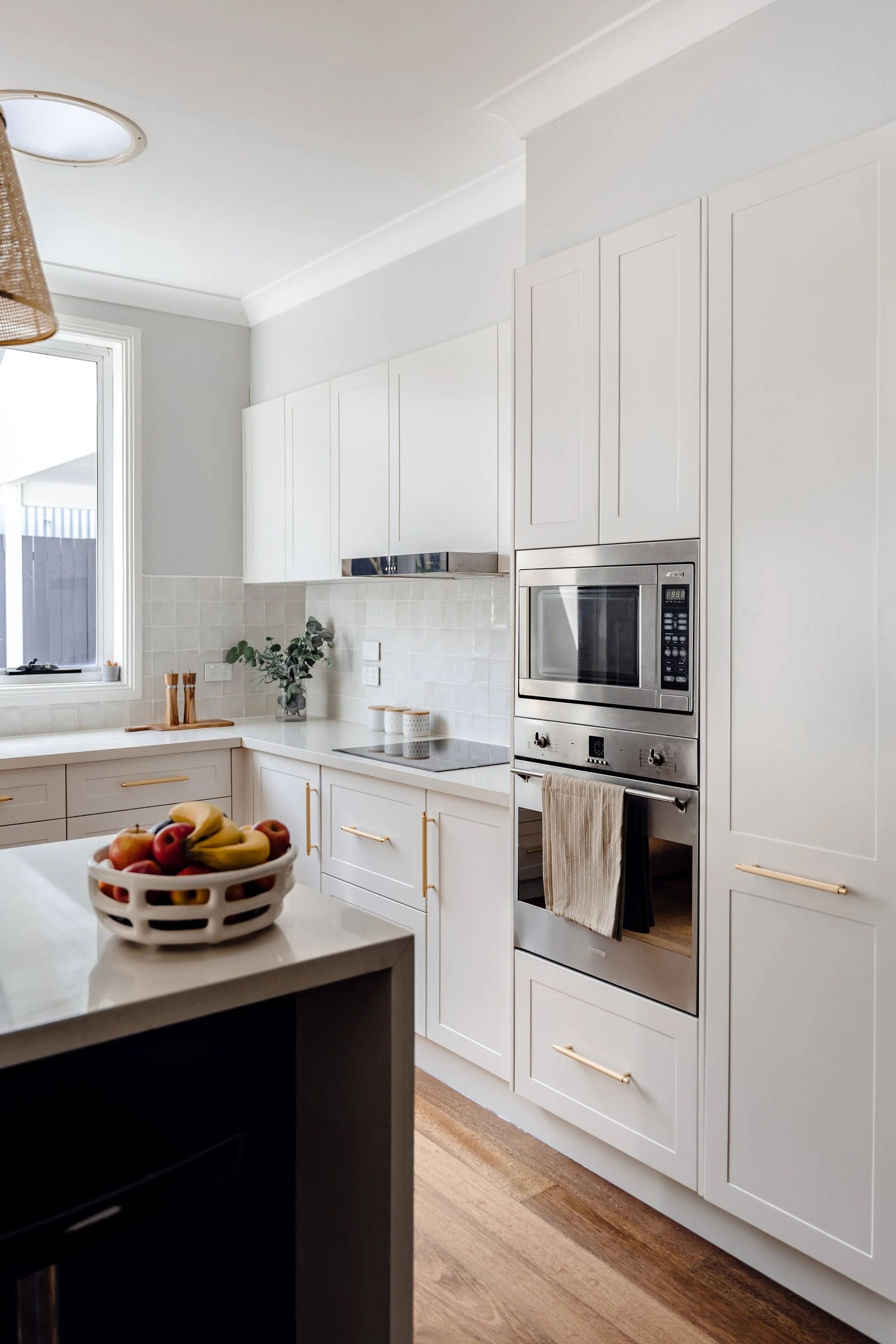 Modern White Kitchen With Stainless Steel Appliances — Onyx Detailed Joinery in Unanderra, NSW
