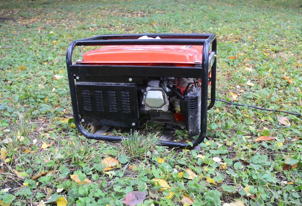An Orange Generator is Sitting on Top of a Lush Green Field — Chaffey Power in West Mackay, QLD