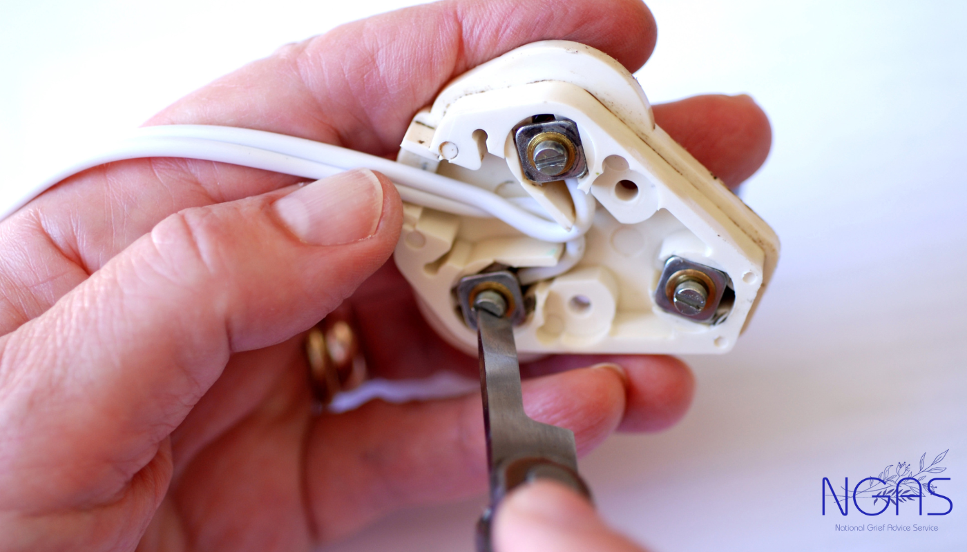 A man is hugging a woman who is crying in front of a mirror.