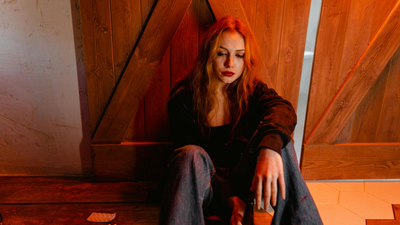 A man is hugging a woman who is crying in front of a mirror.