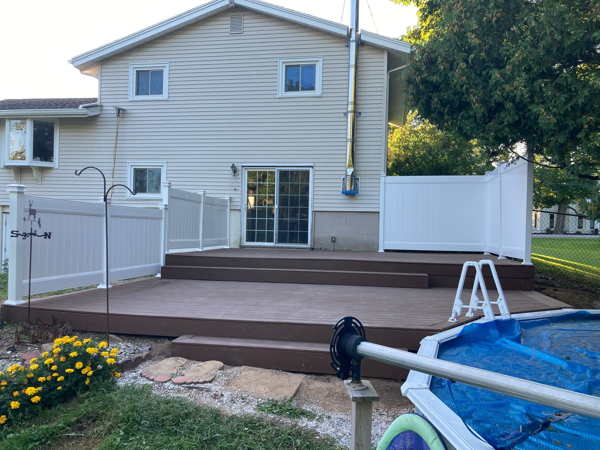 The back of a house with a deck and a pool.