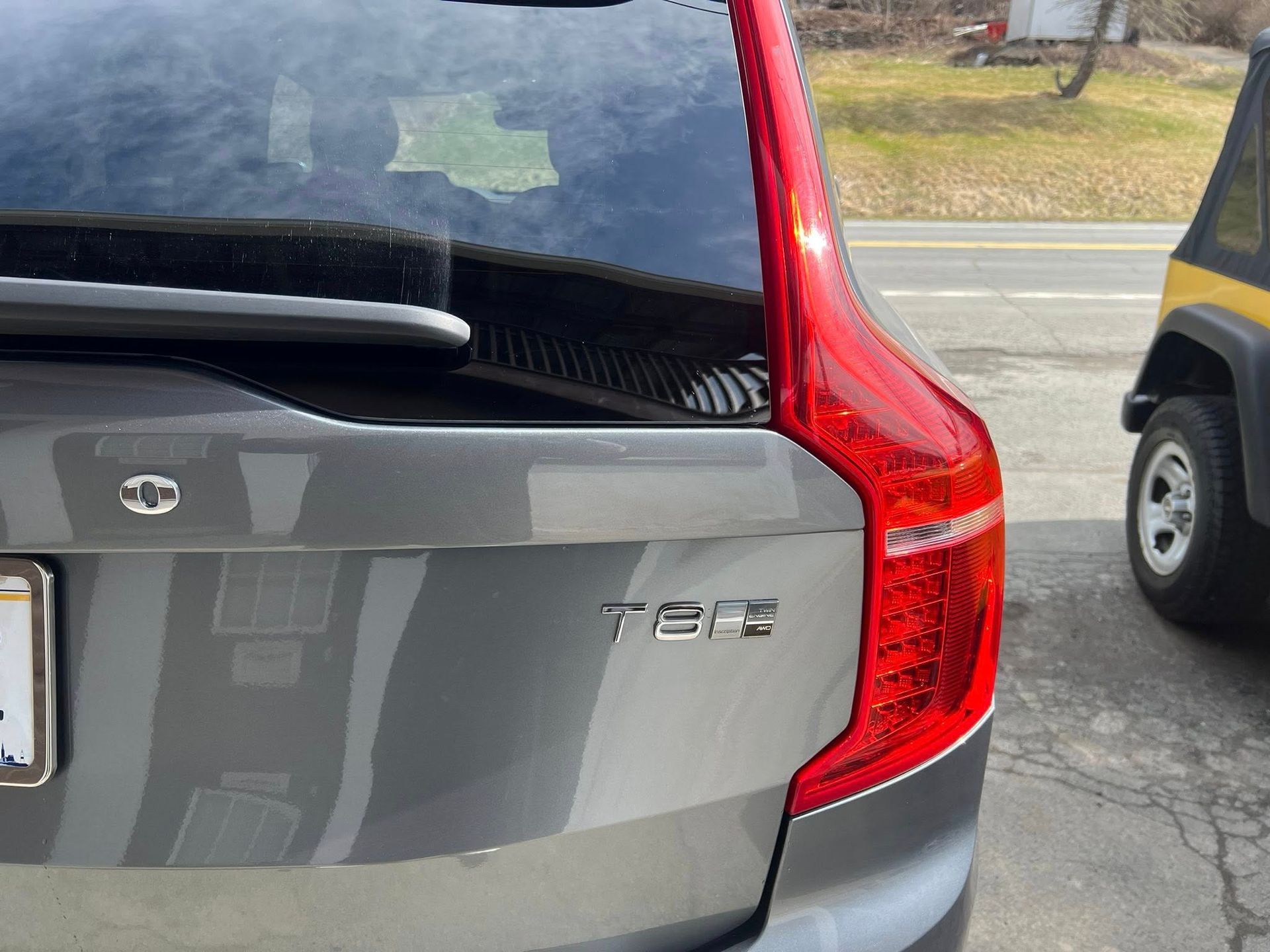 Rear view of a gray Volvo SUV with red taillight and