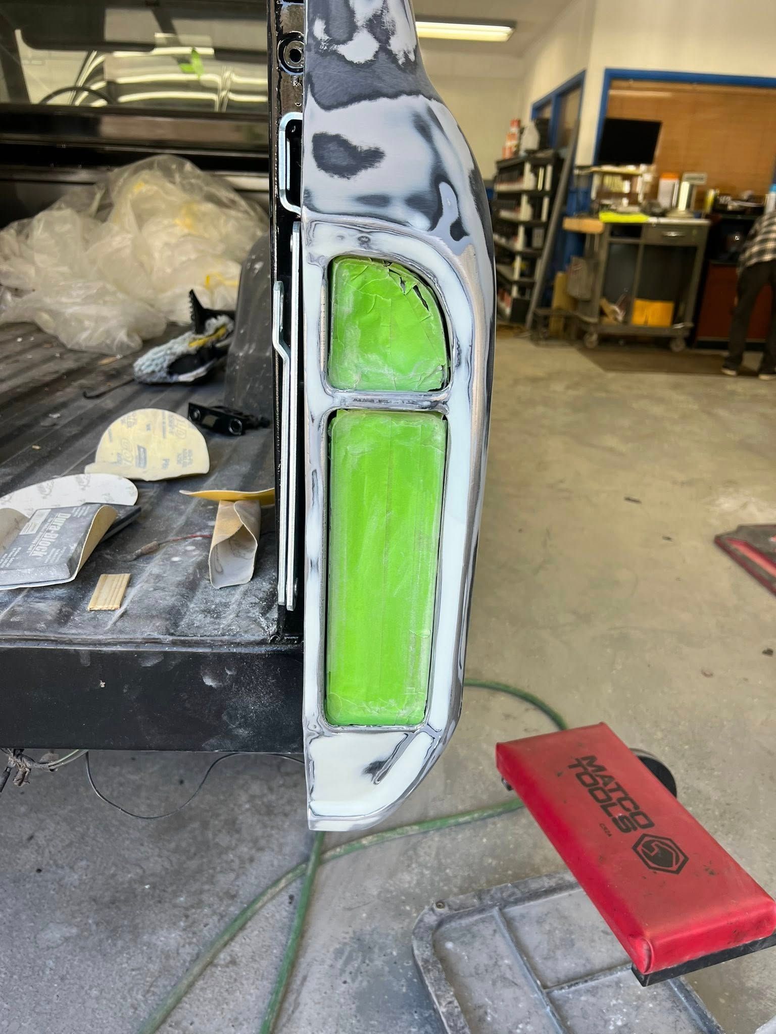 Red Alfa Romeo 4C sports car speeding down a road with blurred background of trees.