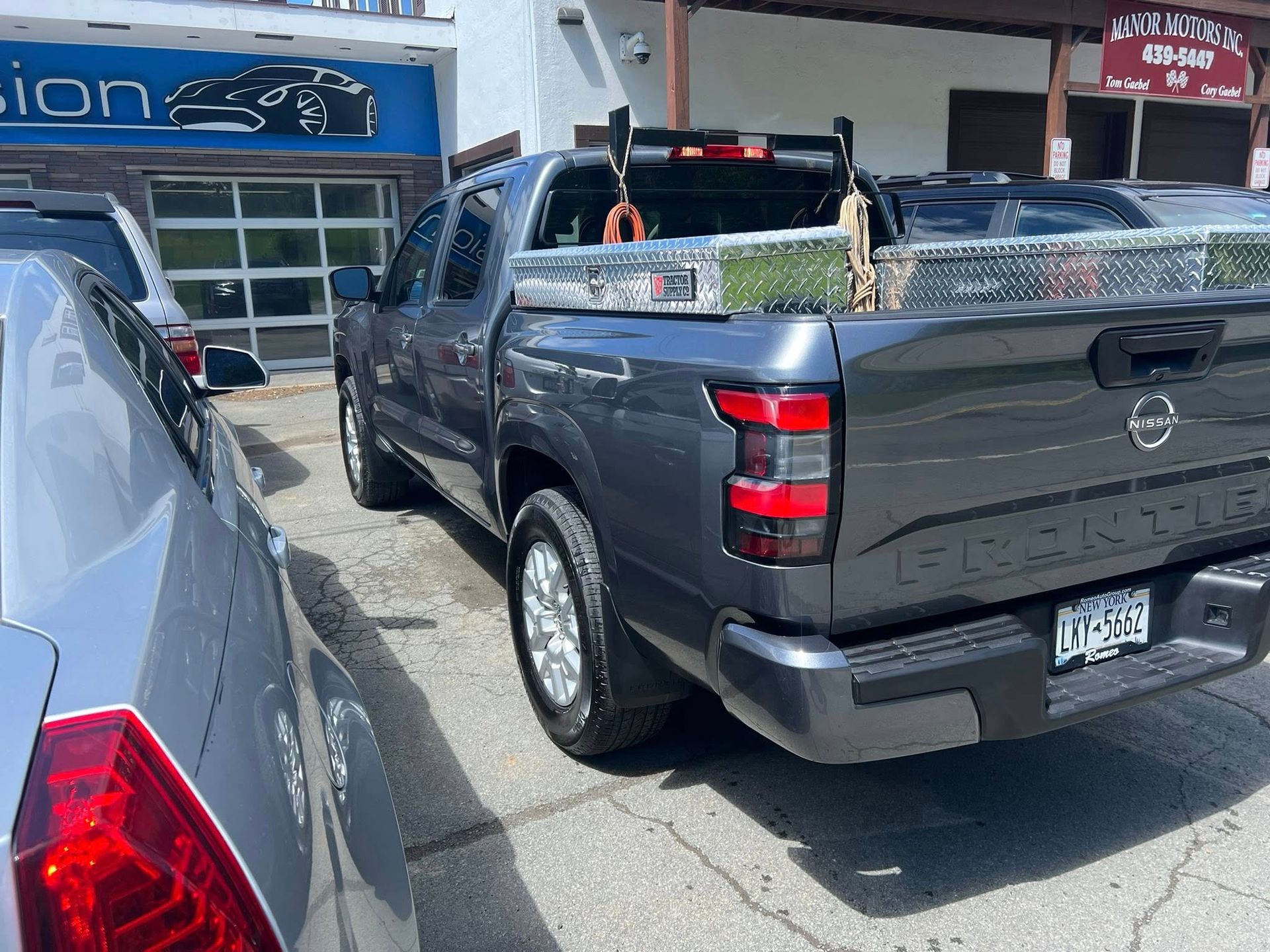 White Toyota Supra parked at night, with streetlights in the background.