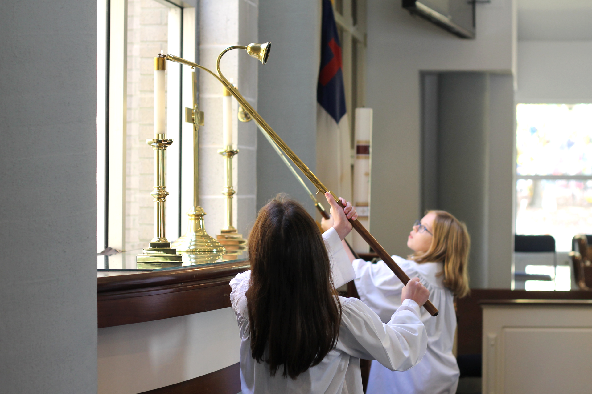 Two acolytes lighting candles at Aldersgate United Methodist Church in north Durham