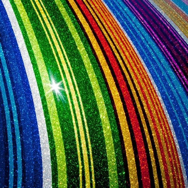 A close up of a colorful striped fabric with a star in the middle