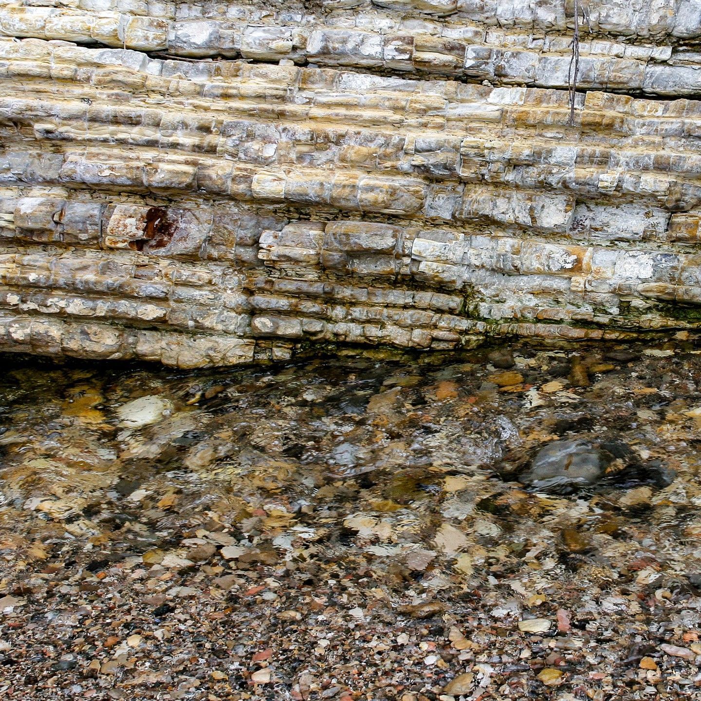 A close up of a rock formation on a beach.