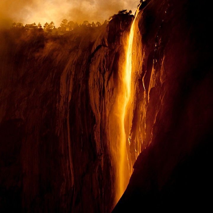 A waterfall is coming down the side of a mountain.