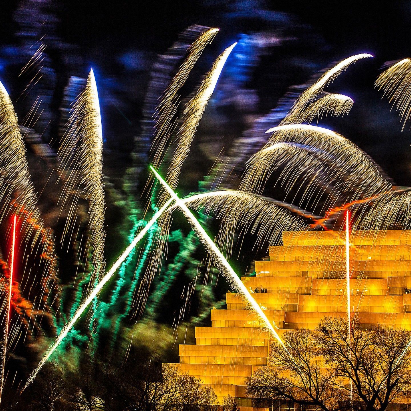 A fireworks display with a pyramid in the background