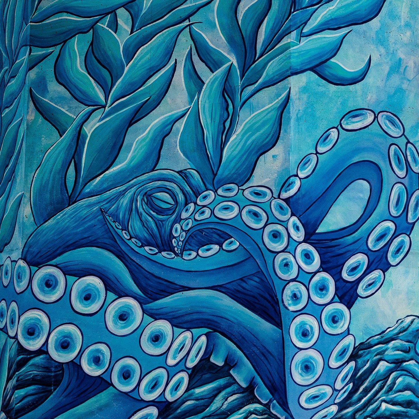 A painting of a blue octopus with lots of tentacles