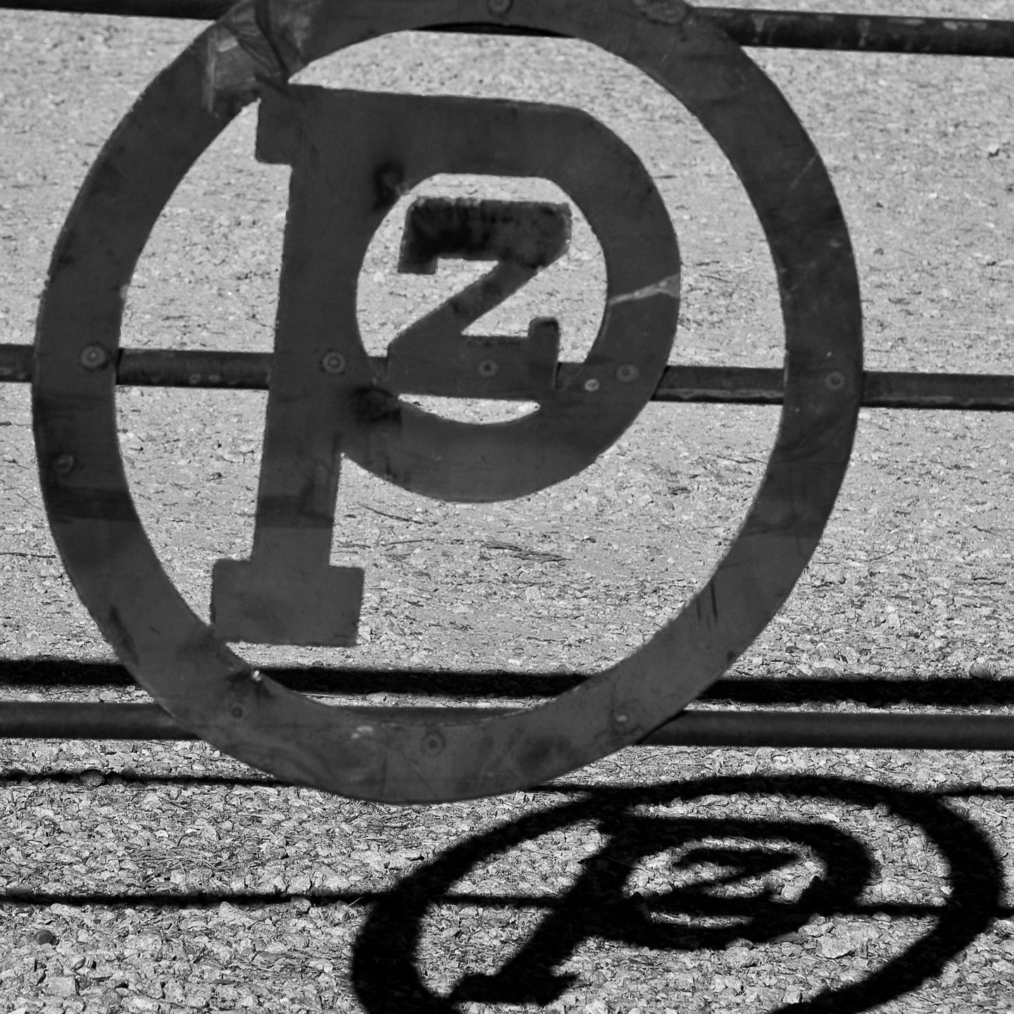 A black and white photo of a parking sign