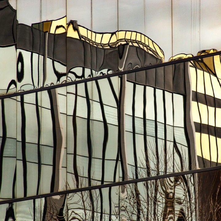 A building with a reflection of trees in the windows