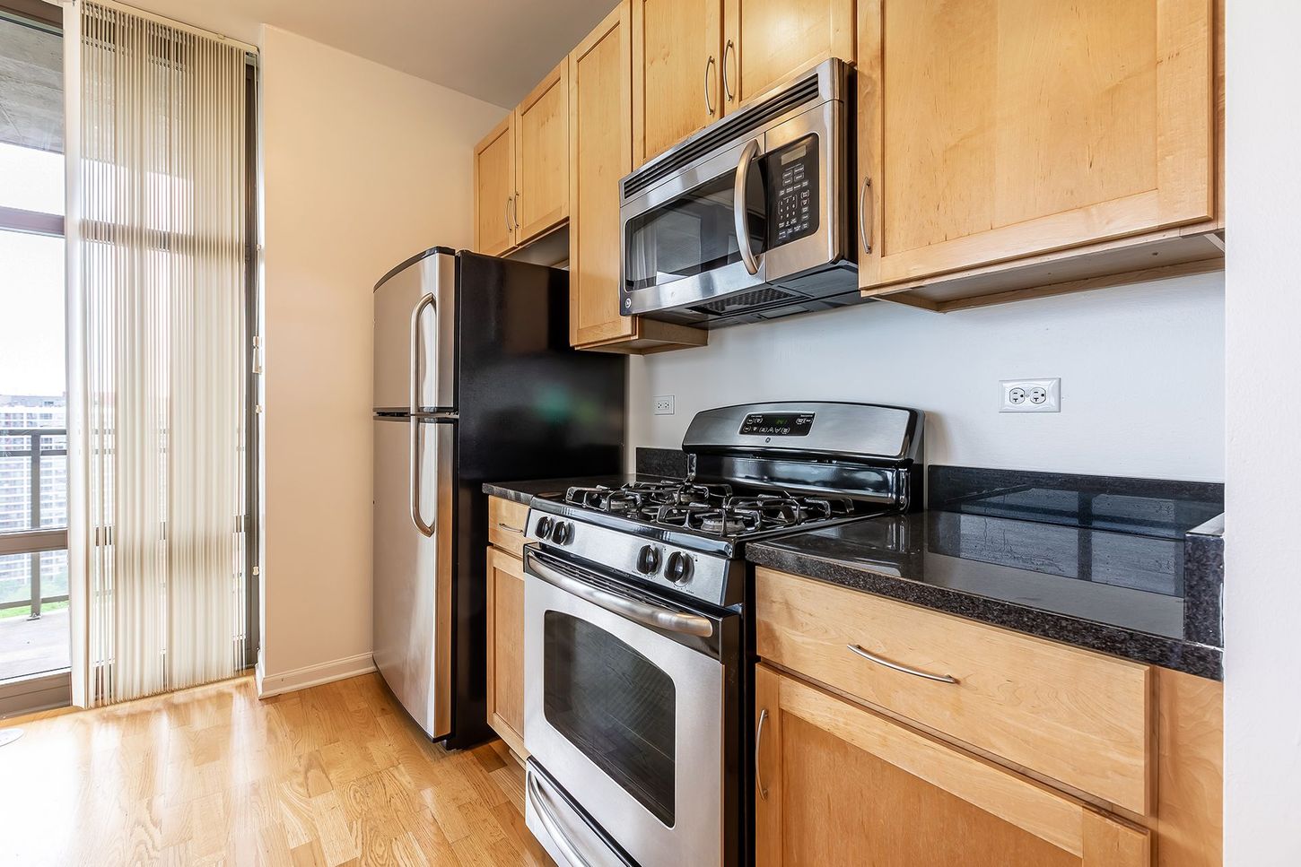 A kitchen with stainless steel appliances and wooden cabinets