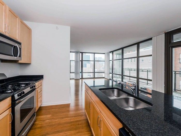 A kitchen with stainless steel appliances and granite counter tops