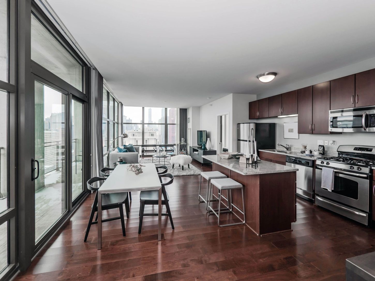 A kitchen with a table and chairs in it