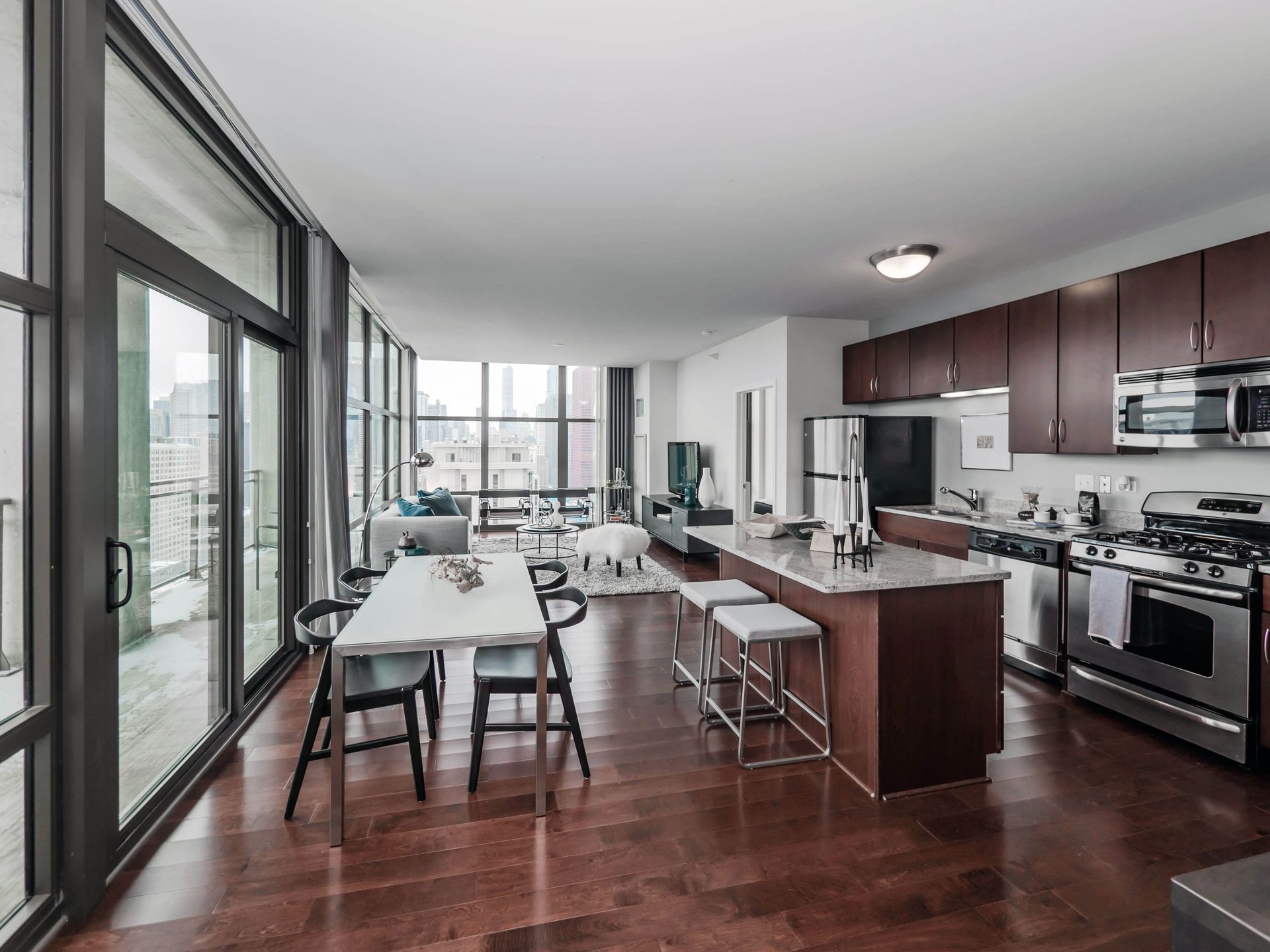 A kitchen with a table and chairs in it