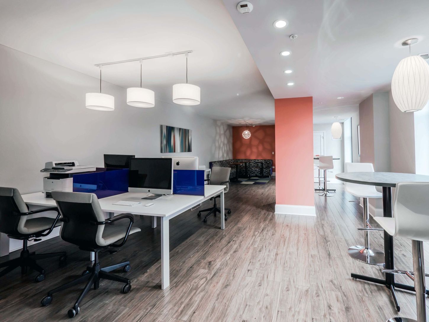 A large office with a lot of desks and chairs.