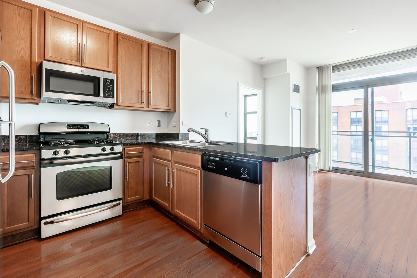 A kitchen with stainless steel appliances and wooden cabinets