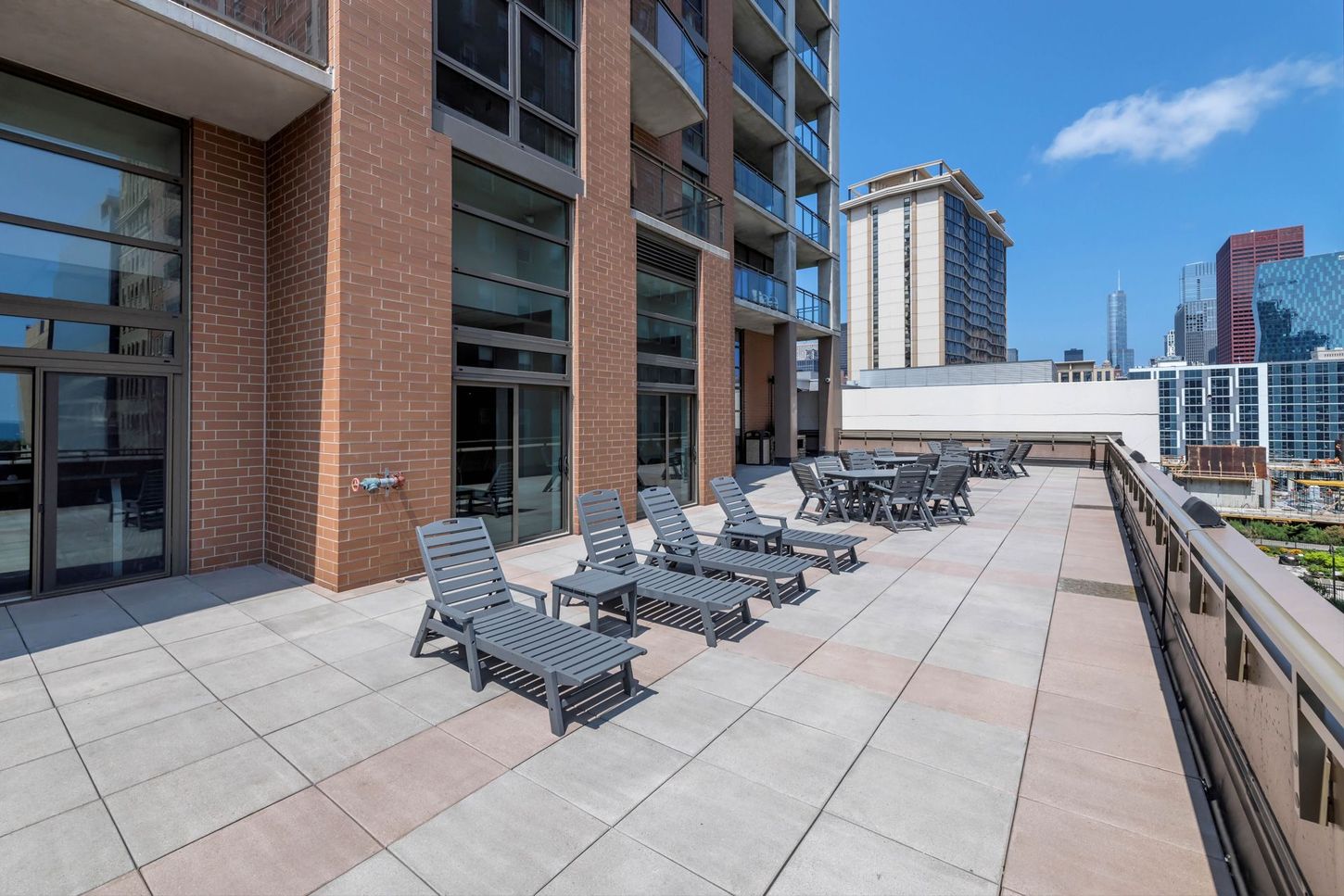 A rooftop deck with a lot of chairs and tables