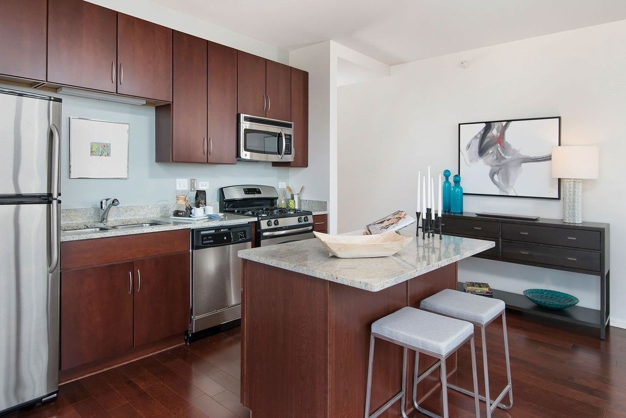 A kitchen with stainless steel appliances and wooden cabinets