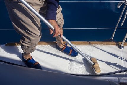 worker scraping the boat