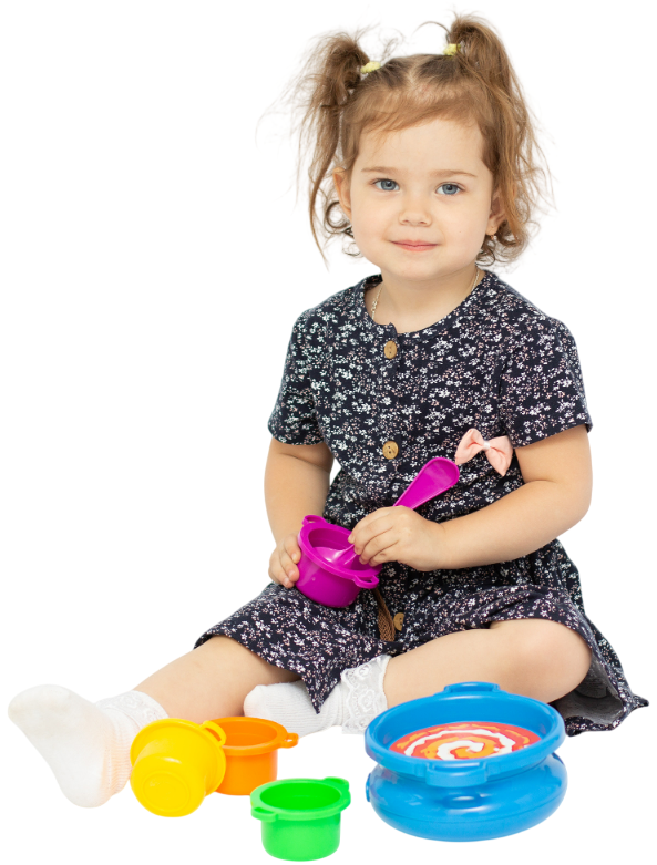 Girl with long curly red hair smiles, wearing a white shirt against a white background.