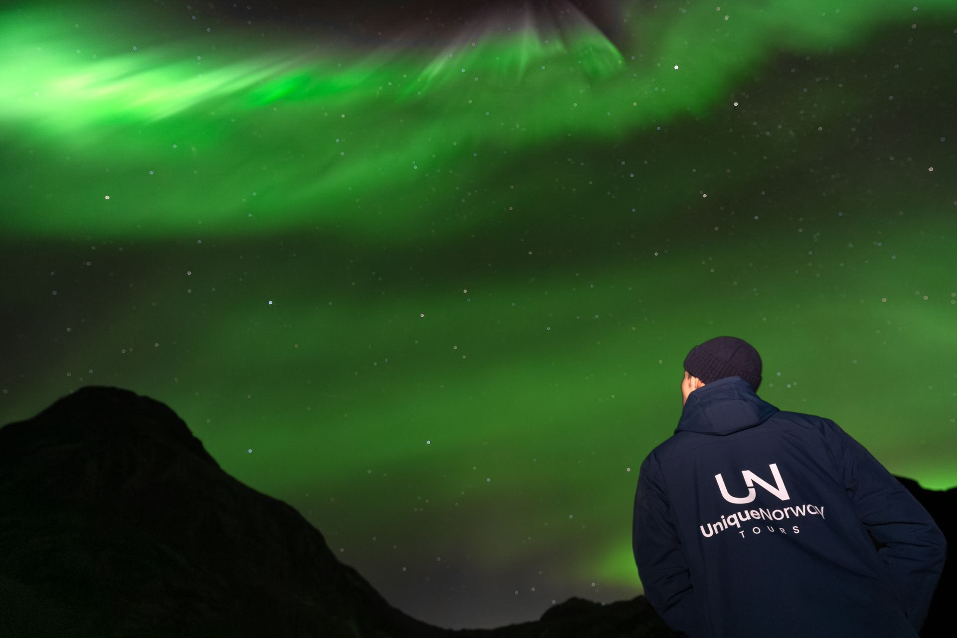 Northern Lights over Tromsø mountains during Unique Norway tour