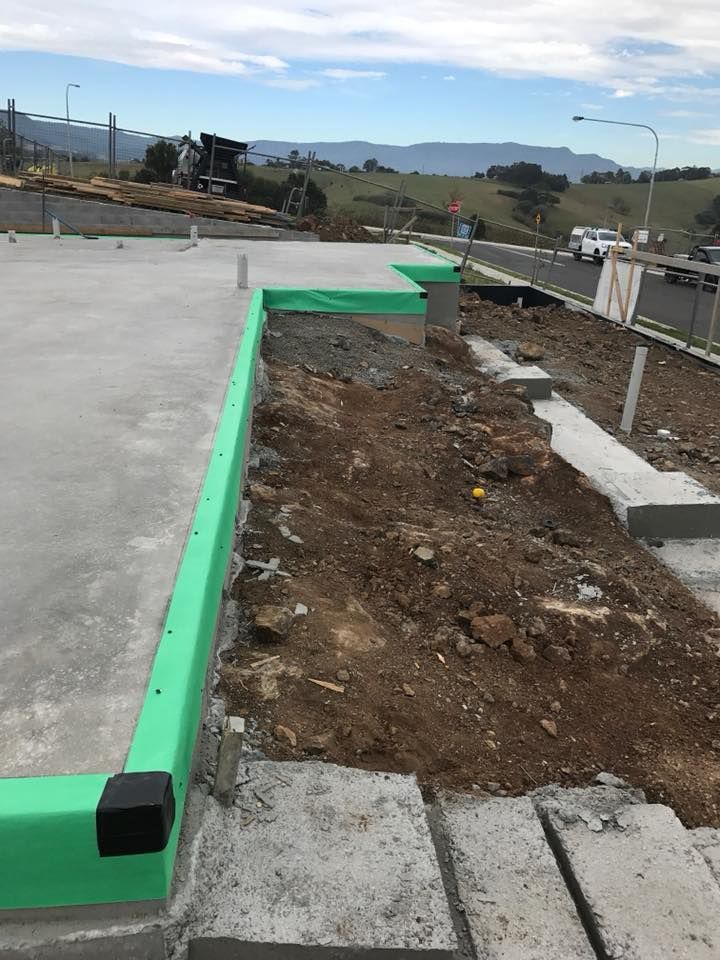A Concrete Slab is Being Built Next to a Road — City Coast Pest Solutions In Wollongong, NSW