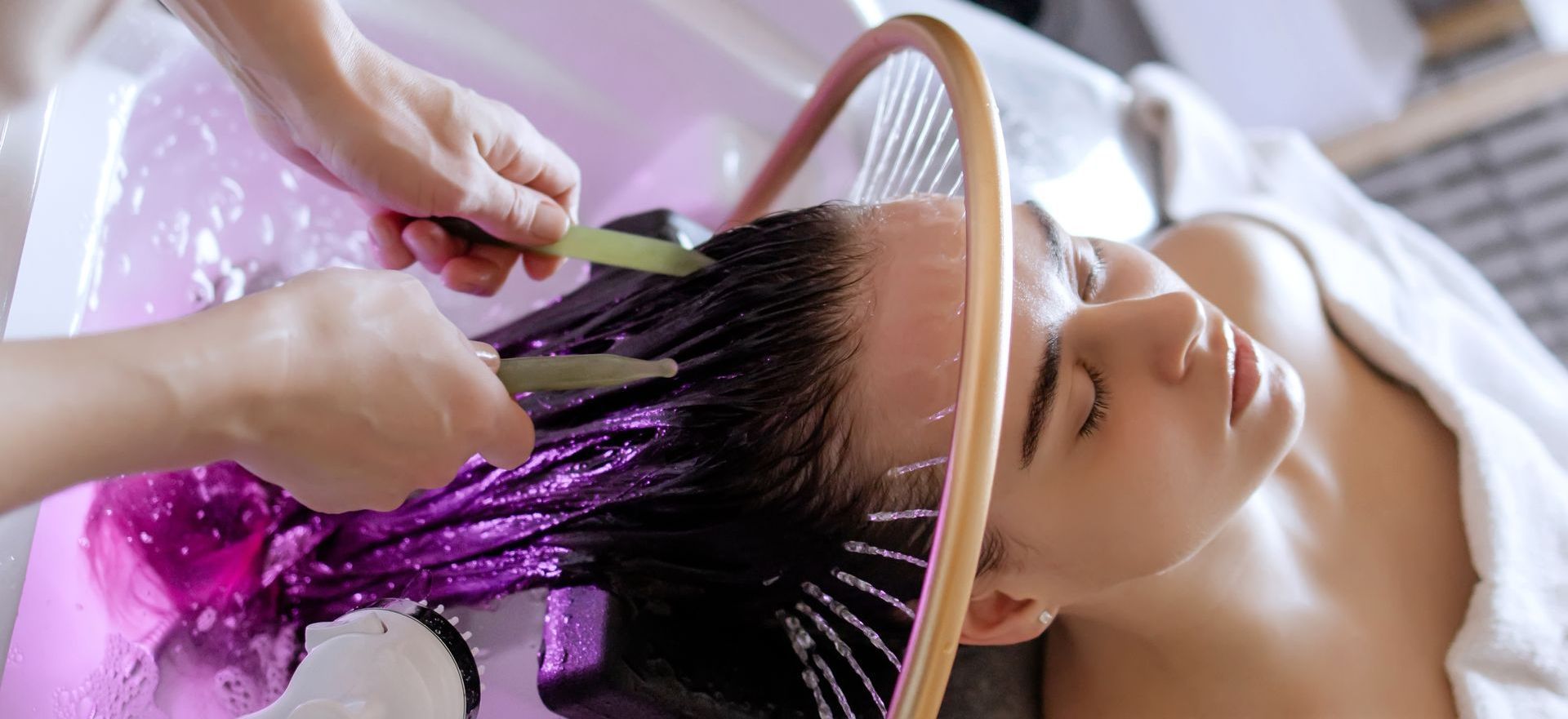A woman is getting a head massage at a spa.