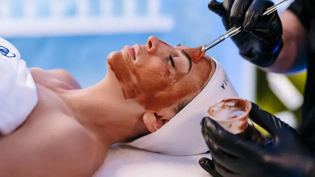 A woman is getting a facial treatment at a spa.