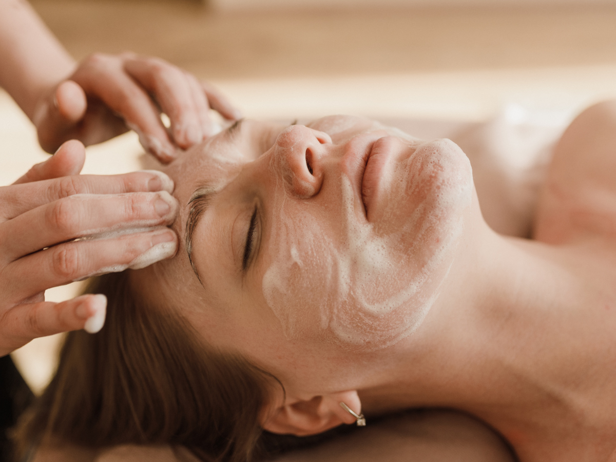 A woman is getting a facial treatment at a spa.