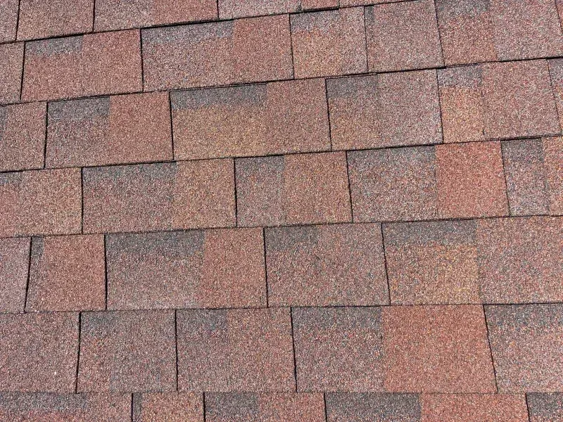 Red and brown asphalt roof shingles.