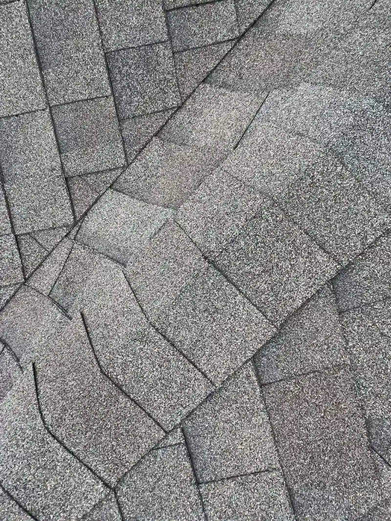 Gray stone paving with irregular, geometric pattern.