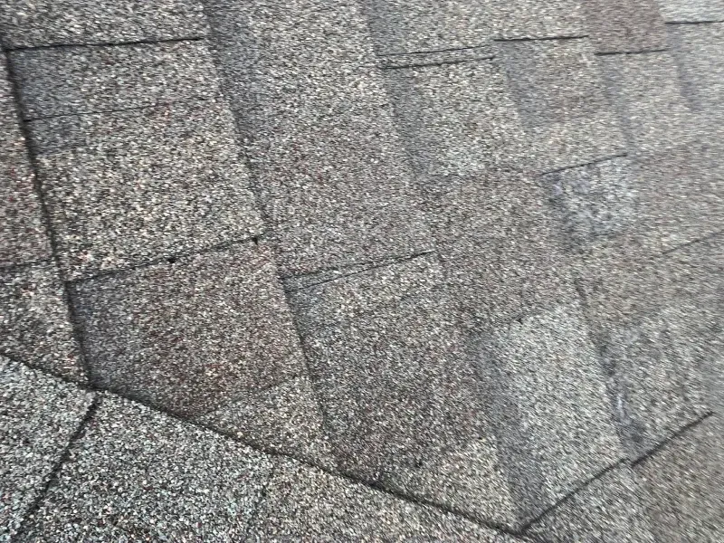 Close-up of weathered gray asphalt roof shingles.
