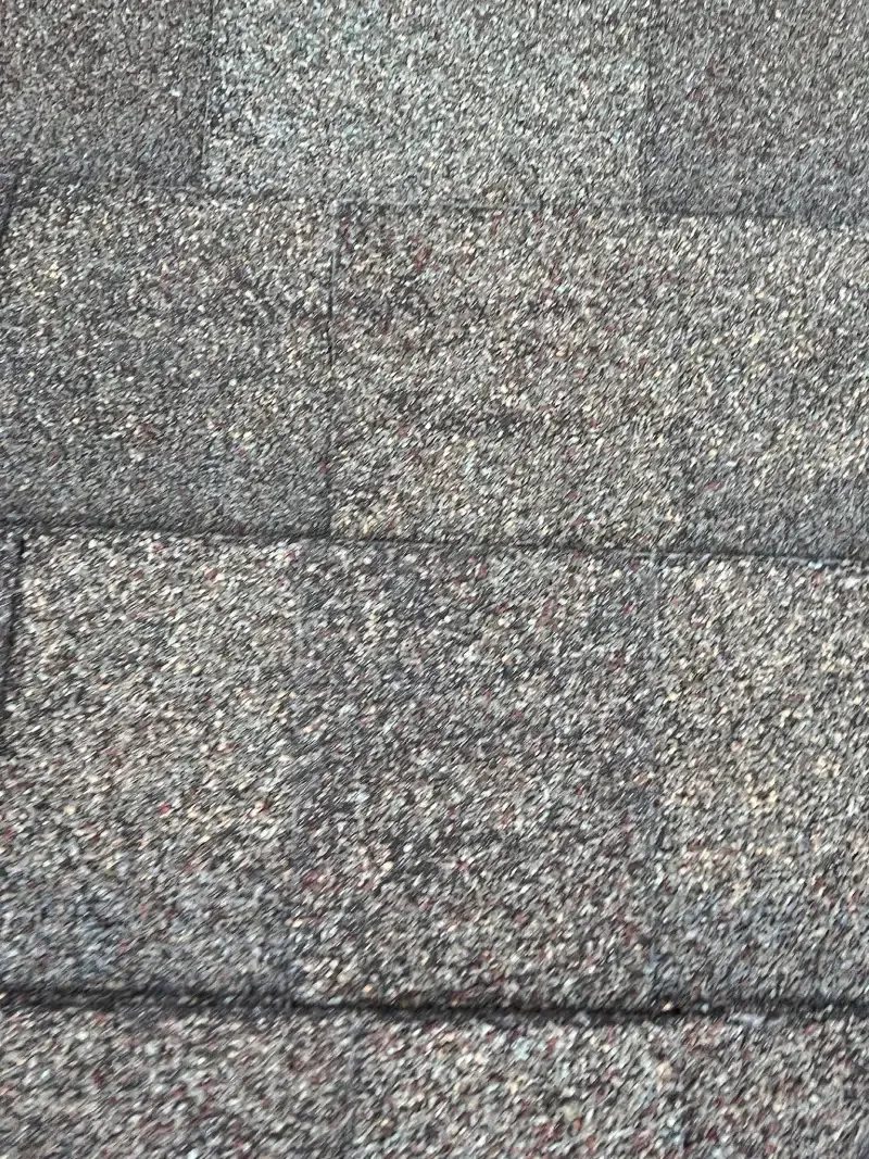 Gray and brown rectangular roof shingles.