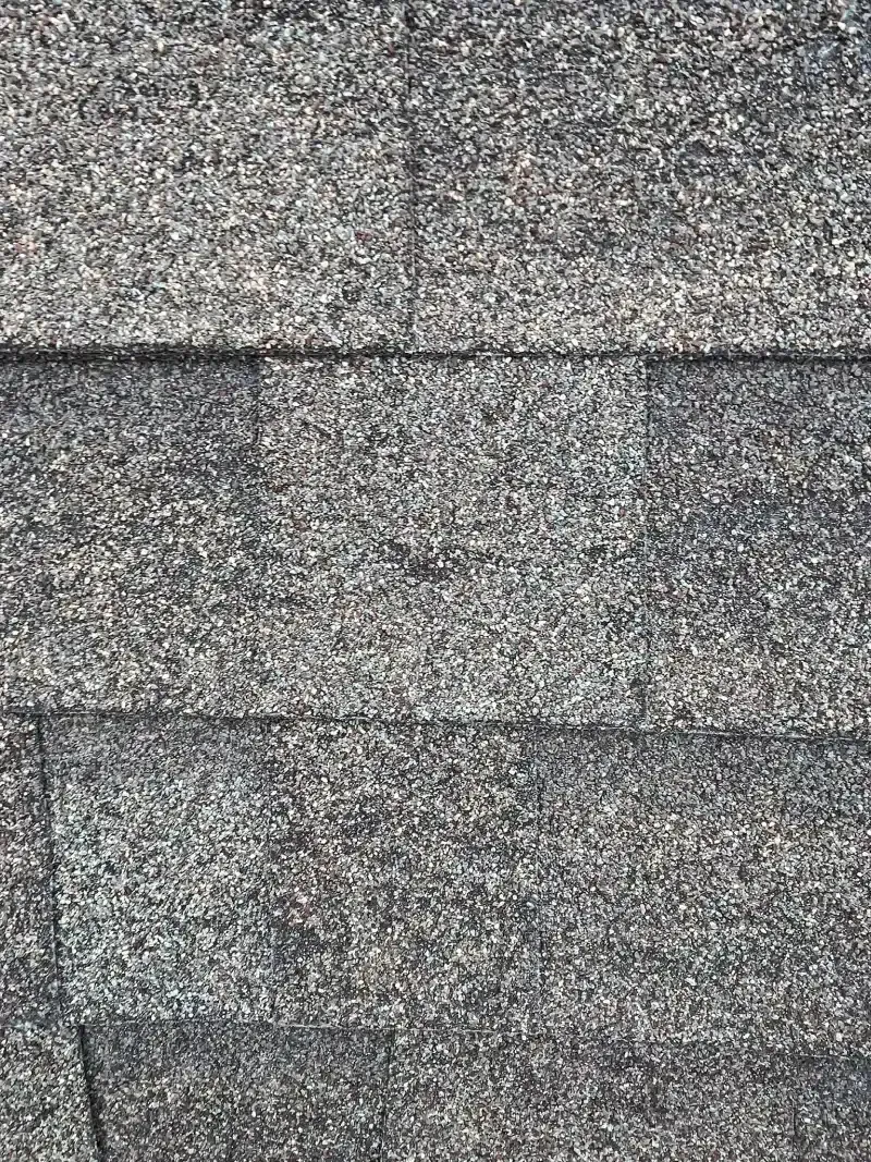 Dark gray asphalt roof shingles.