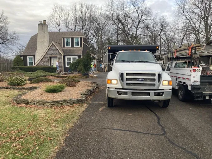 A white truck is parked in front of a house.