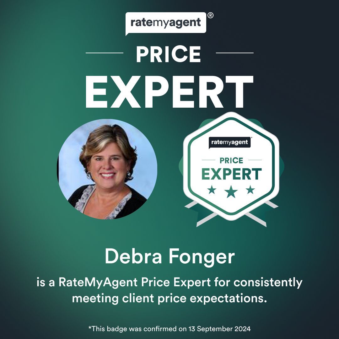 A patio with a lot of furniture and lights at night.