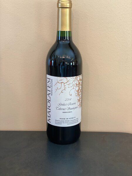 A bottle of alcohol with a white label that says 